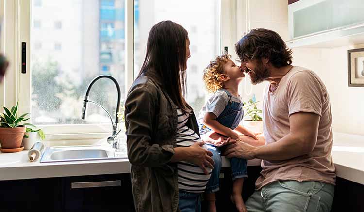 Mom Dad and Daughter Standing in Kitchen.jpg