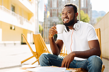 African American Man On Balcony With Cup