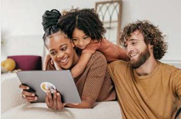 Mix Race Family Looking At Tablet